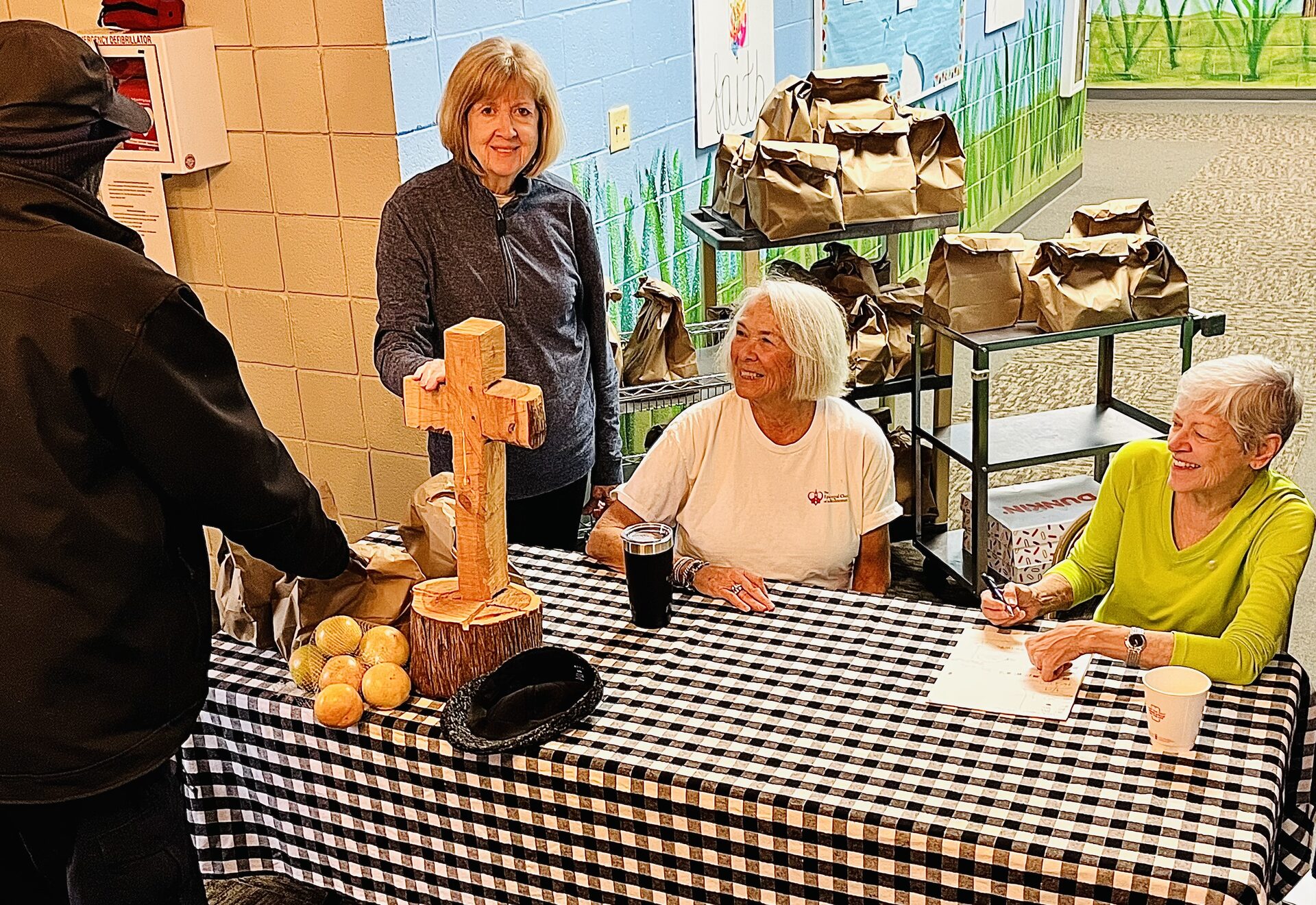 A guest is warmly welcomed at Our Father's Kitchen